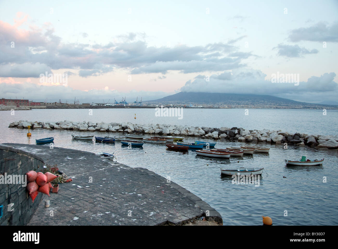 Naples Harbour, Italy with a cloud covered Mount Vesuvius in the distance Stock Photo