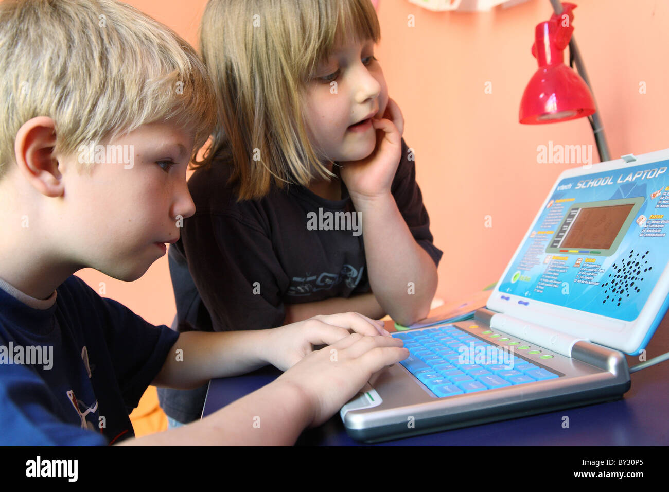 Two children learning from a children's computer Stock Photo Alamy