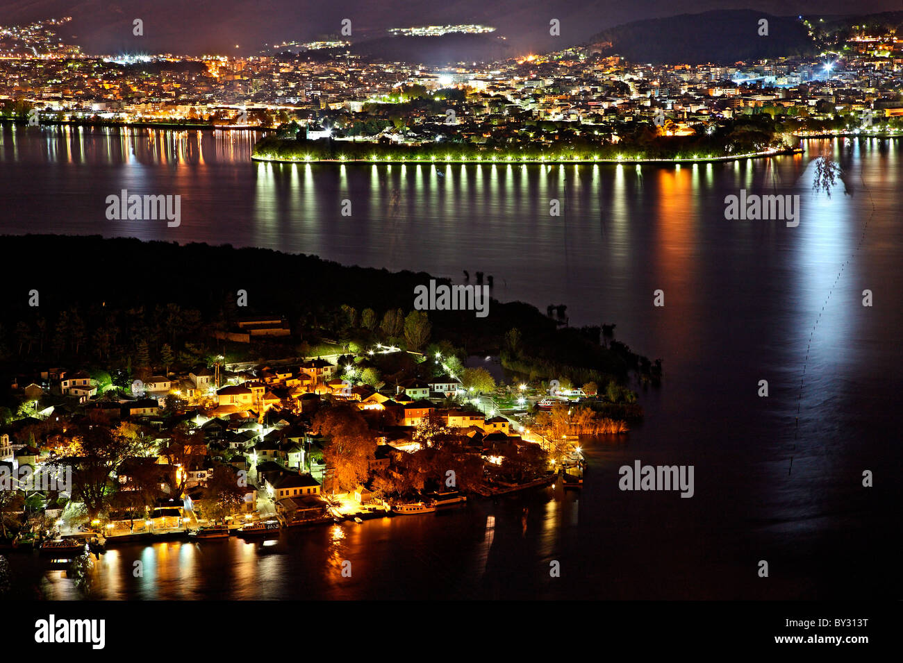 Panoramic night view of Ioannina town, its lake ('Pamvotis' or 'Pamvotida'), the islet of the lake and its village. Greece Stock Photo