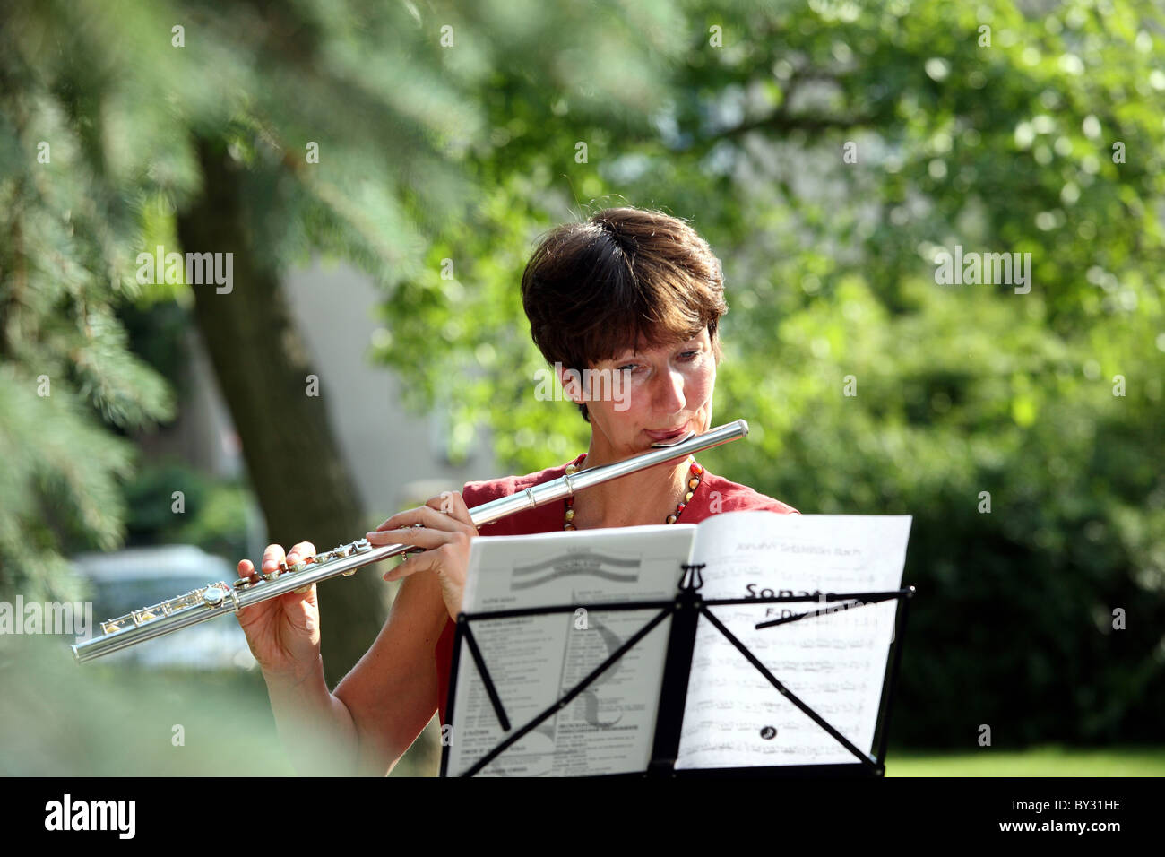 A woman playing a Western concert flute Stock Photo