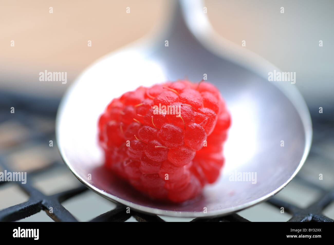 Raspberry on the old silver spoon Stock Photo - Alamy