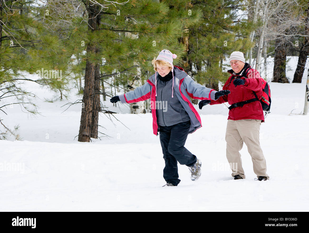 Active retired couple playing in the snow Stock Photo