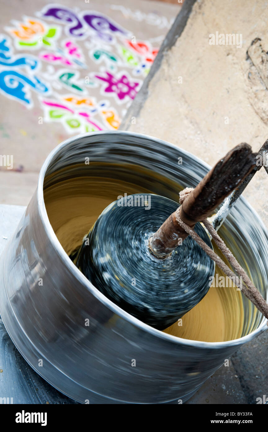 Motorized grinder by an indian house grinding dal and jaggery for preparation of indian sweets at festival time. Andhra Pradesh, India Stock Photo