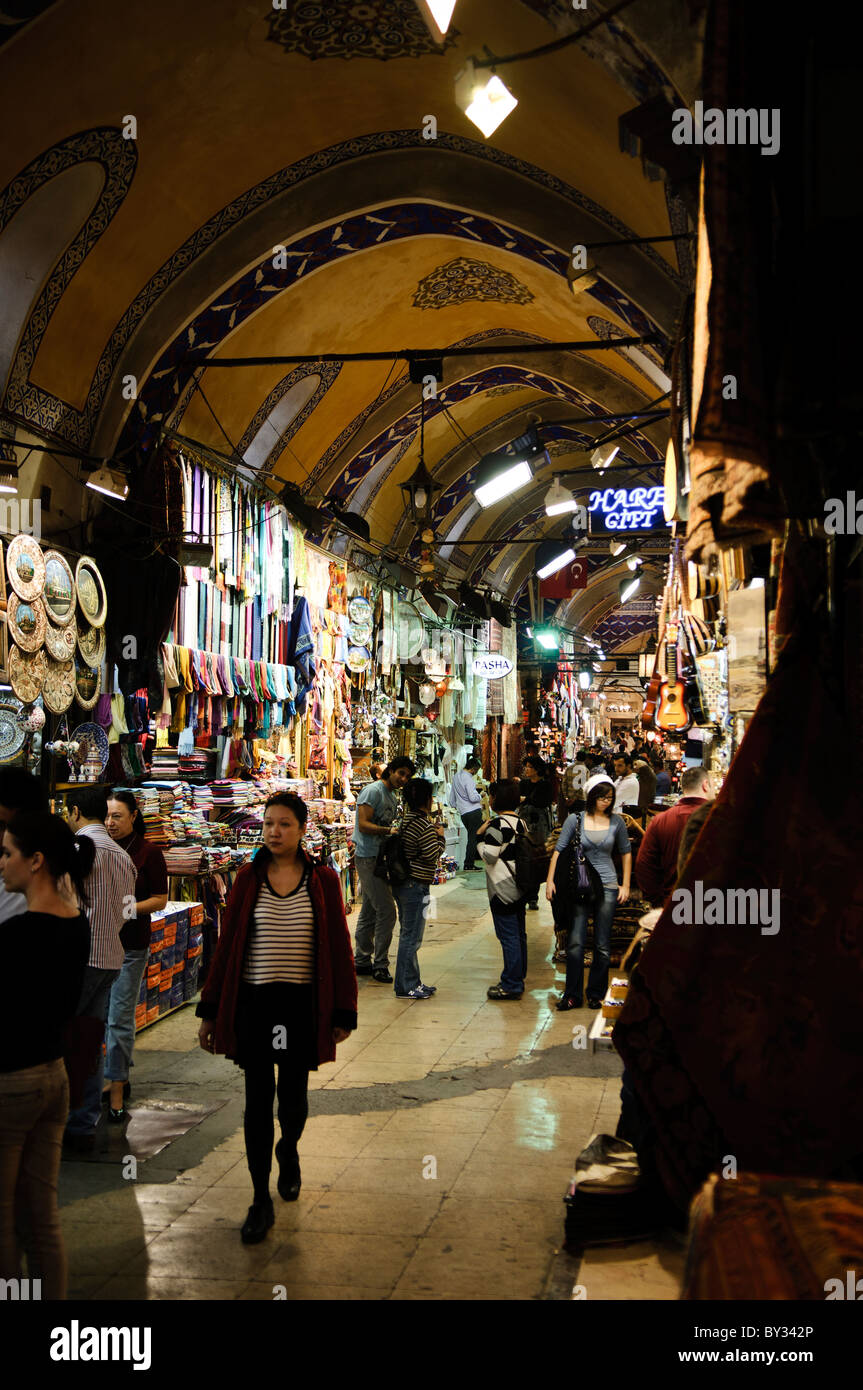 ISTANBUL, Turkey — Customers in one of the many streets of Istanbul's historic Grand Bazaar The Grand Bazaar, one of the largest and oldest covered markets in the world, is a bustling hub of commerce and culture in Istanbul. Featuring a maze of over 4,000 shops, it offers a vibrant array of goods, from spices and jewelry to textiles and ceramics. The Grand Bazaar's historic architecture and lively atmosphere attract millions of visitors each year. Stock Photo