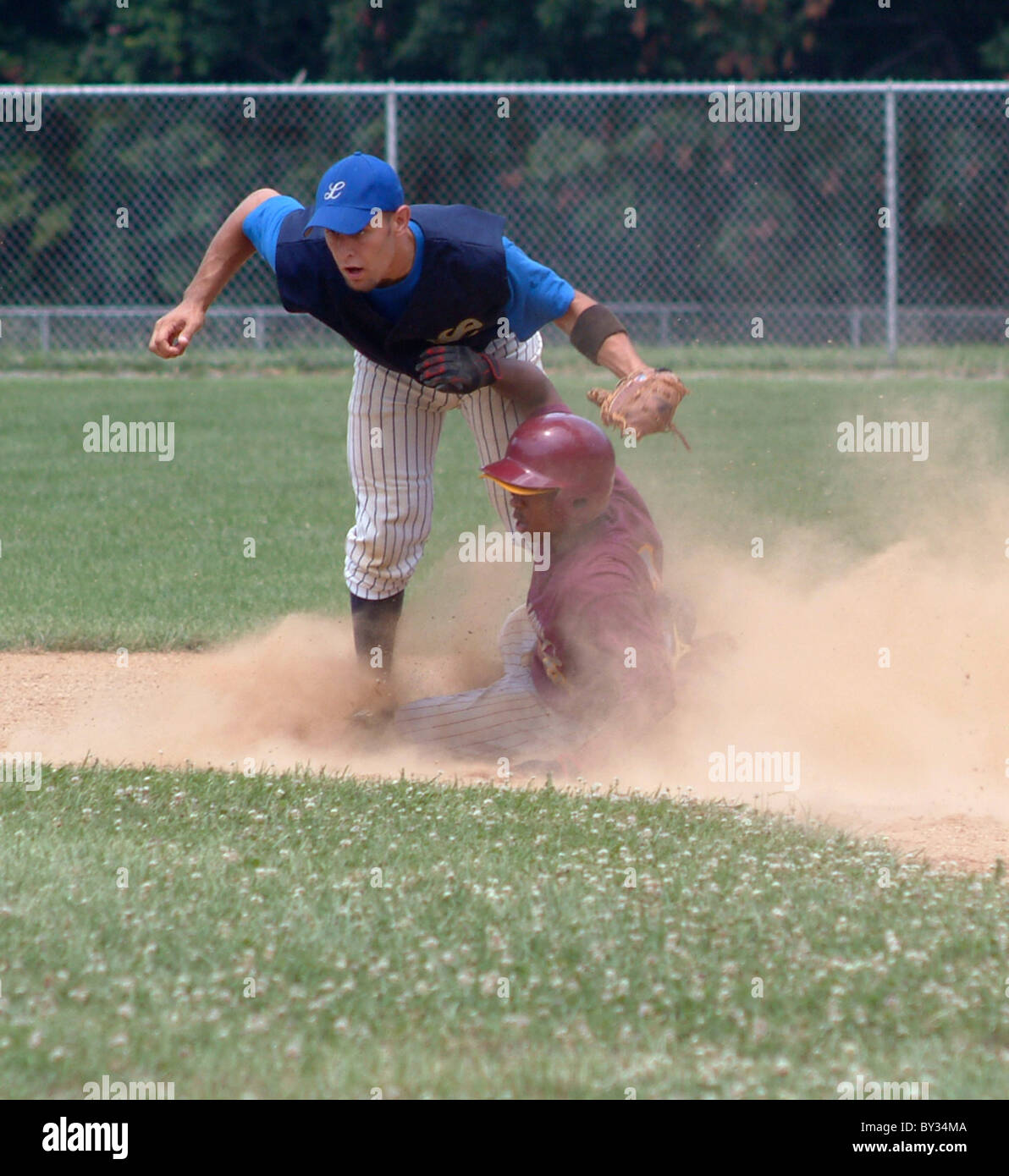 Player slides and is safe on base in a high school baseball game Stock ...