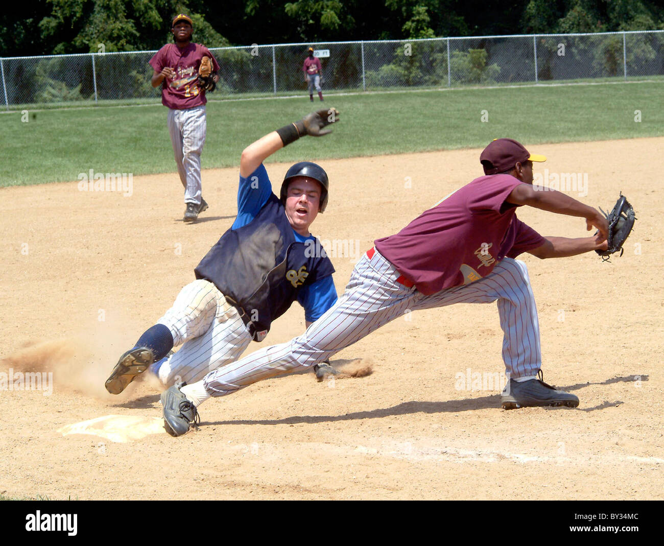 Player slides and is safe on base in a high school baseball game Stock ...