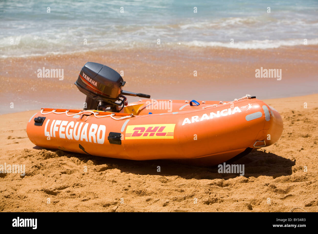Orange surf rescue lifeguard dinghy boat with Yamaha outboard motor
