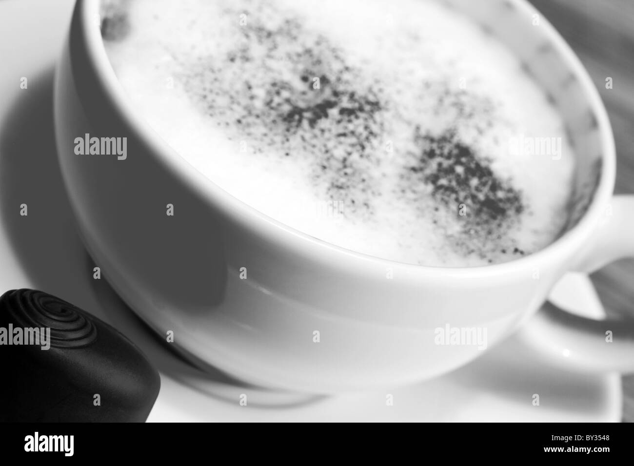 Close up of a cappuccino cup and saucer with a chocolate Stock Photo