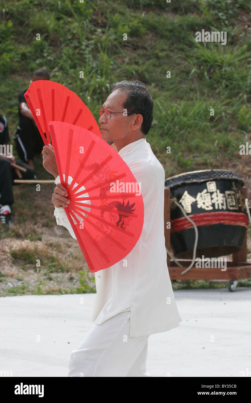 Asian man demonstrating martial arts at Duanwu Festival (Chinese: 端午節/端午节), aka the Dragon Boat Festival. Stock Photo