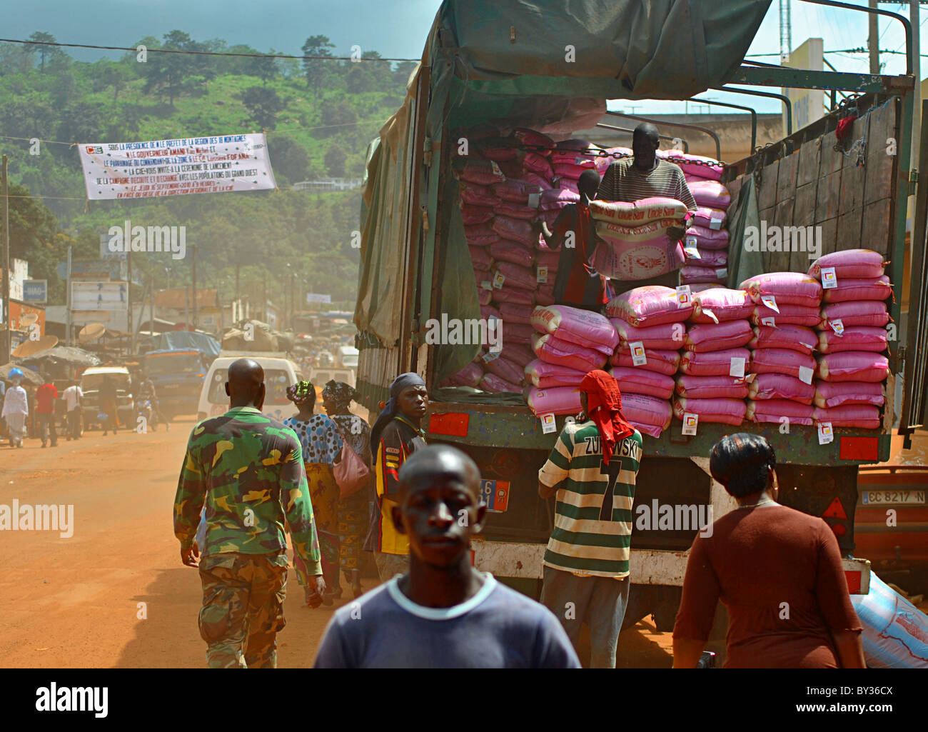 People unload sacks from a lorry in the town of Man in northern rebel-held Ivory Coast, West Africa Stock Photo