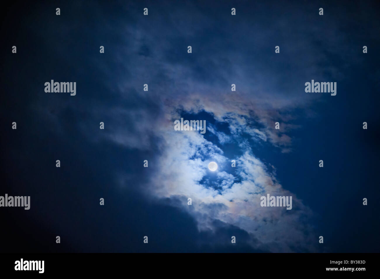 Full moon in cloudy sky at night Stock Photo - Alamy