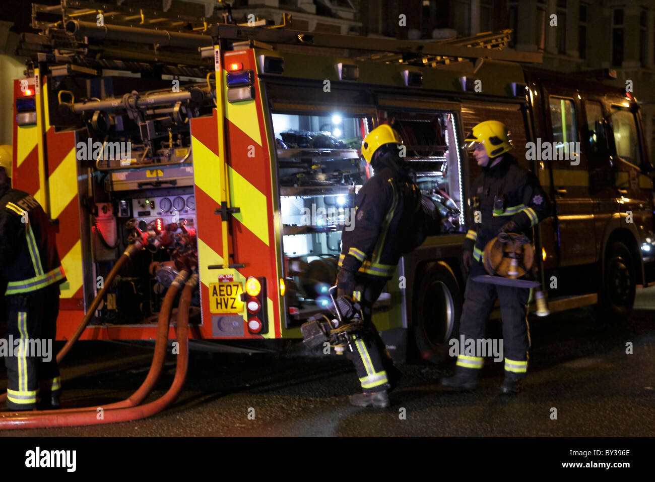 Crews getting kit of a fire engine Stock Photo - Alamy