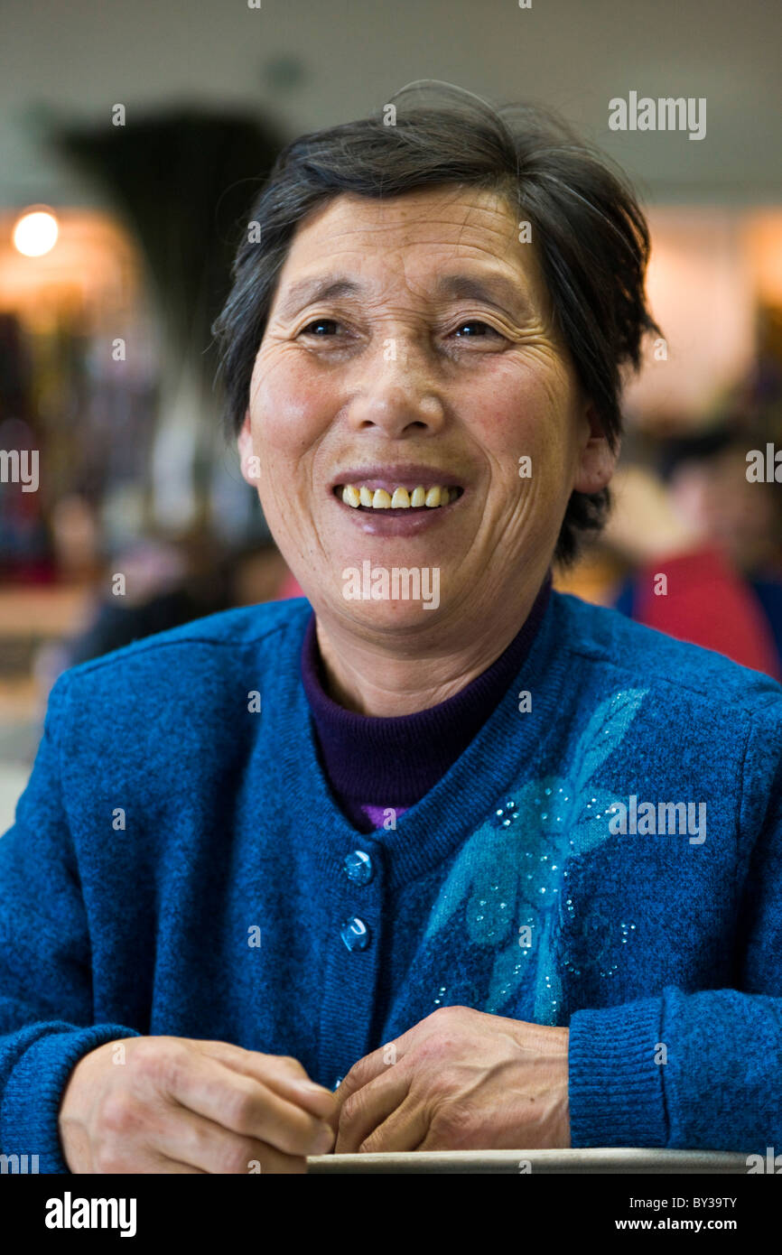 Smiling Chinese woman at Guangzhou Airport China in southern China. JMH4166 Stock Photo