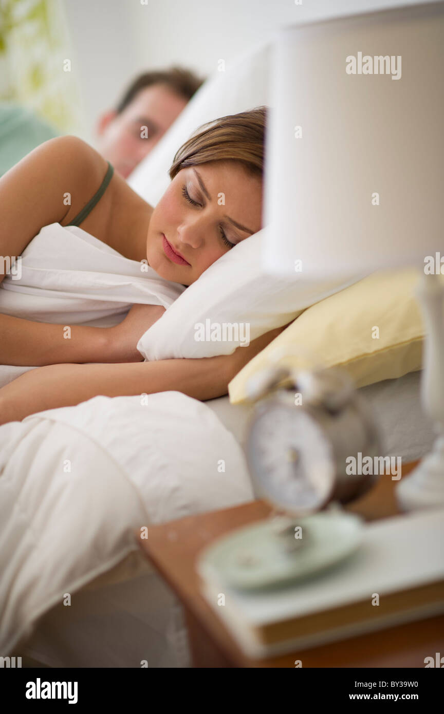 USA, New Jersey, Jersey City, Young couple sleeping in bed Stock Photo