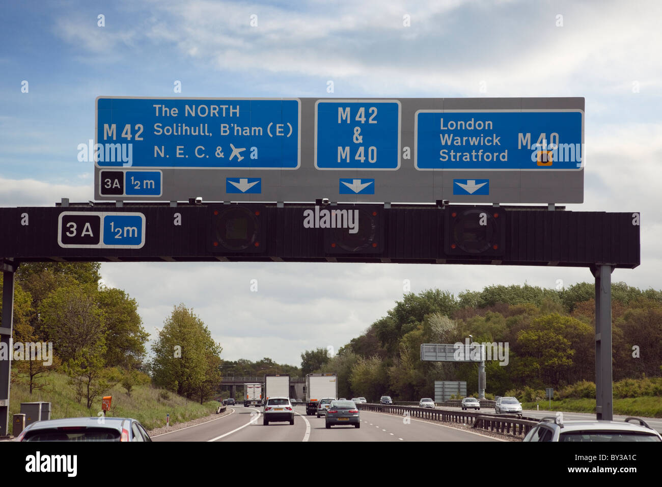 Overhead gantry Motorway signs above the M42 before junction 3A for the M40 route across the country. Midlands, England, UK, Britain Stock Photo