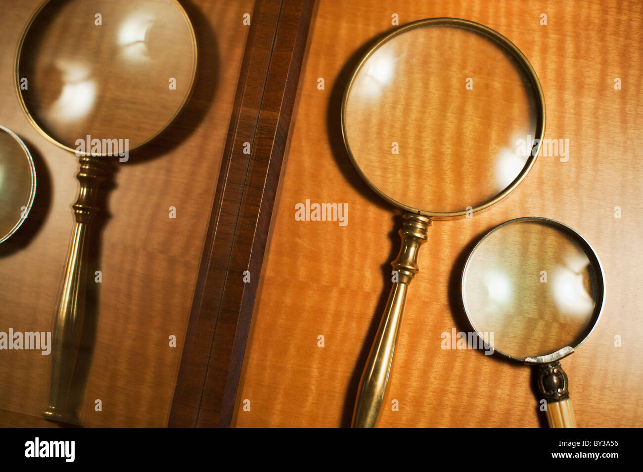 USA, New Jersey, Jersey City, Two magnifying glasses reflected in mirror Stock Photo