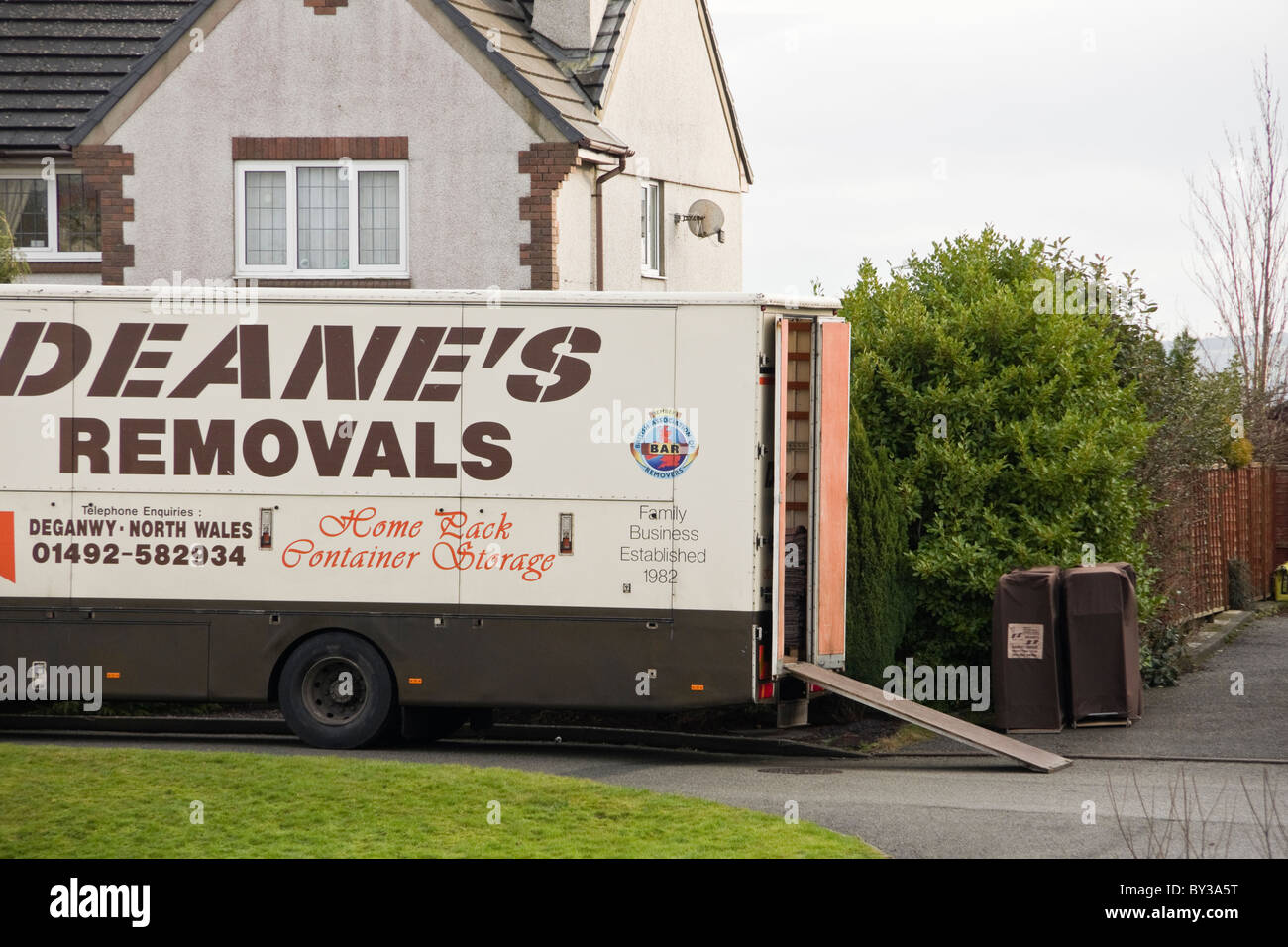 North Wales, UK, Europe. Furniture removal van in the street outside a house for home removals Stock Photo