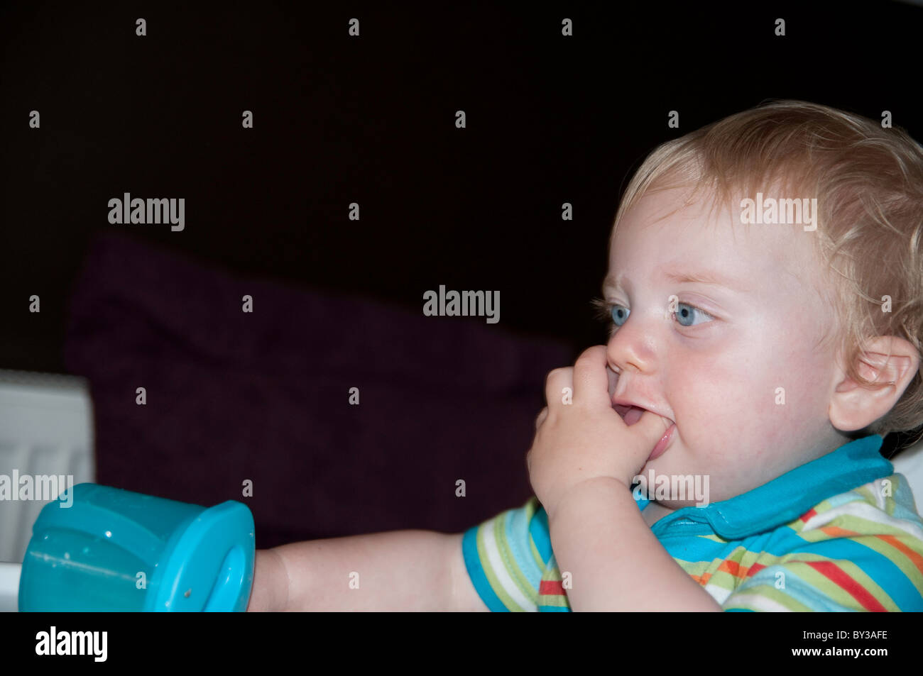 Toddler with drinking beaker Stock Photo Alamy