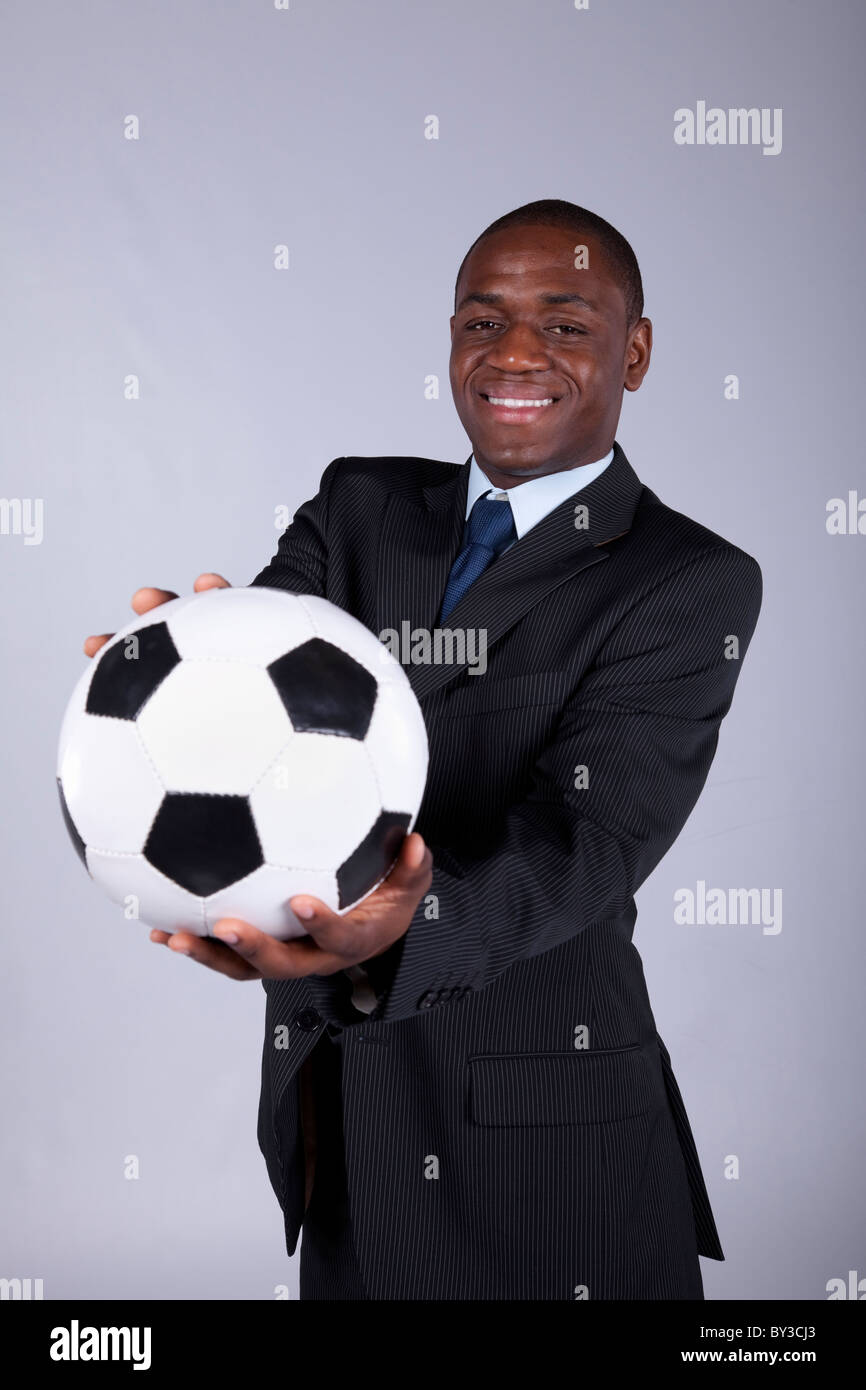 African businessman holding a soccer ball Stock Photo - Alamy