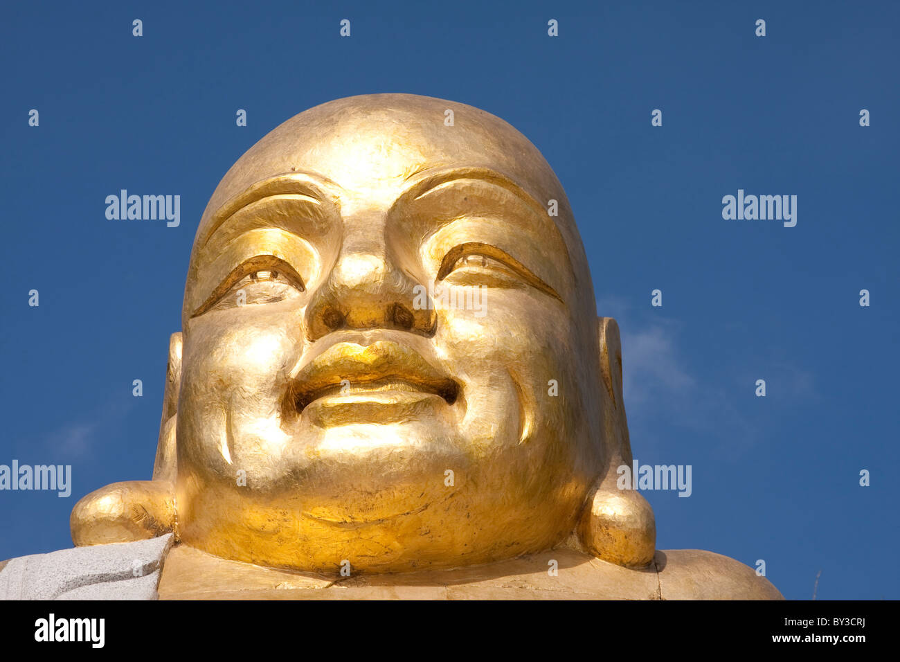 Golden buddha head with the sky as background Stock Photo