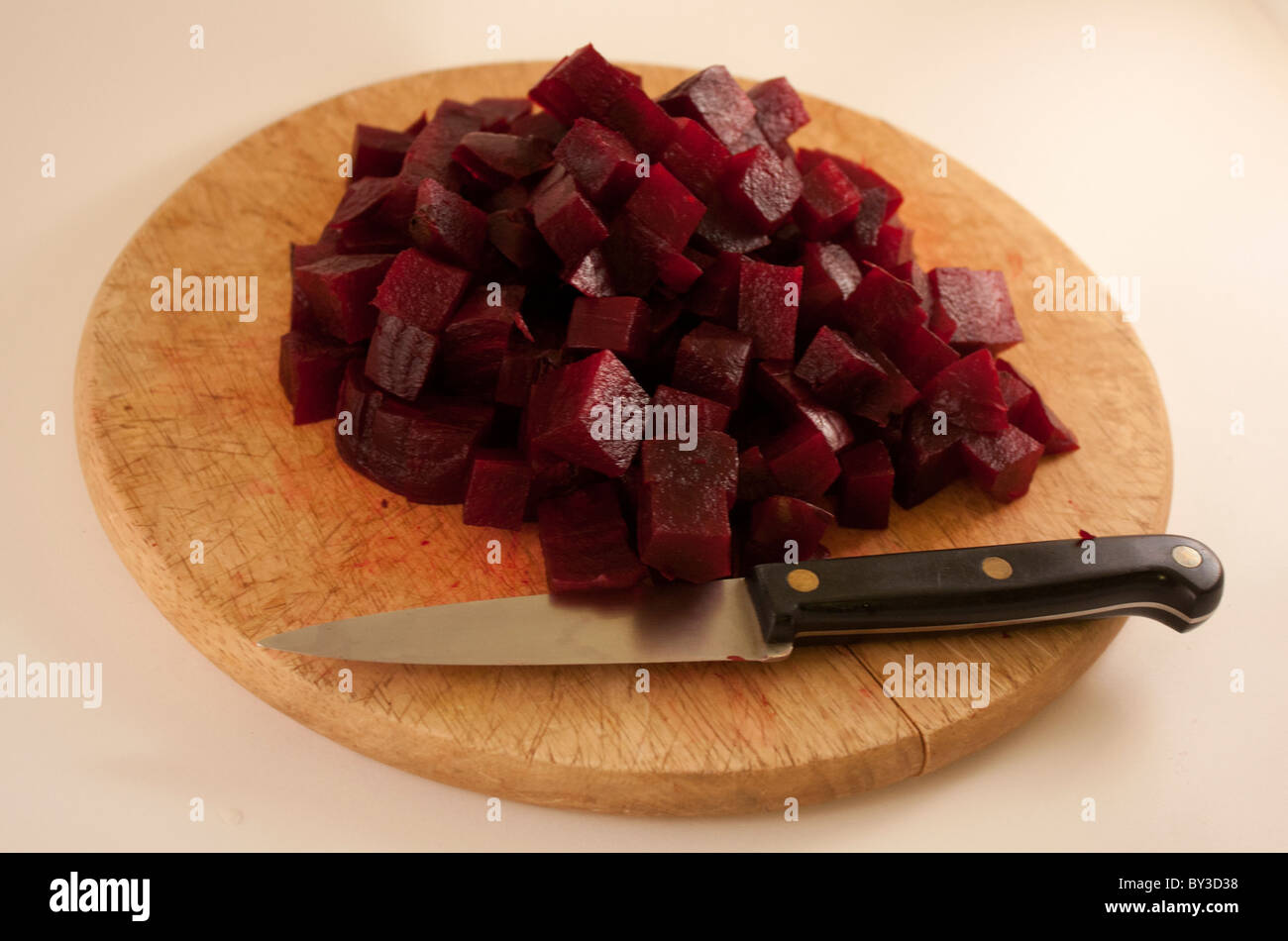 cooked chopped beetroot on a round wooden board Stock Photo