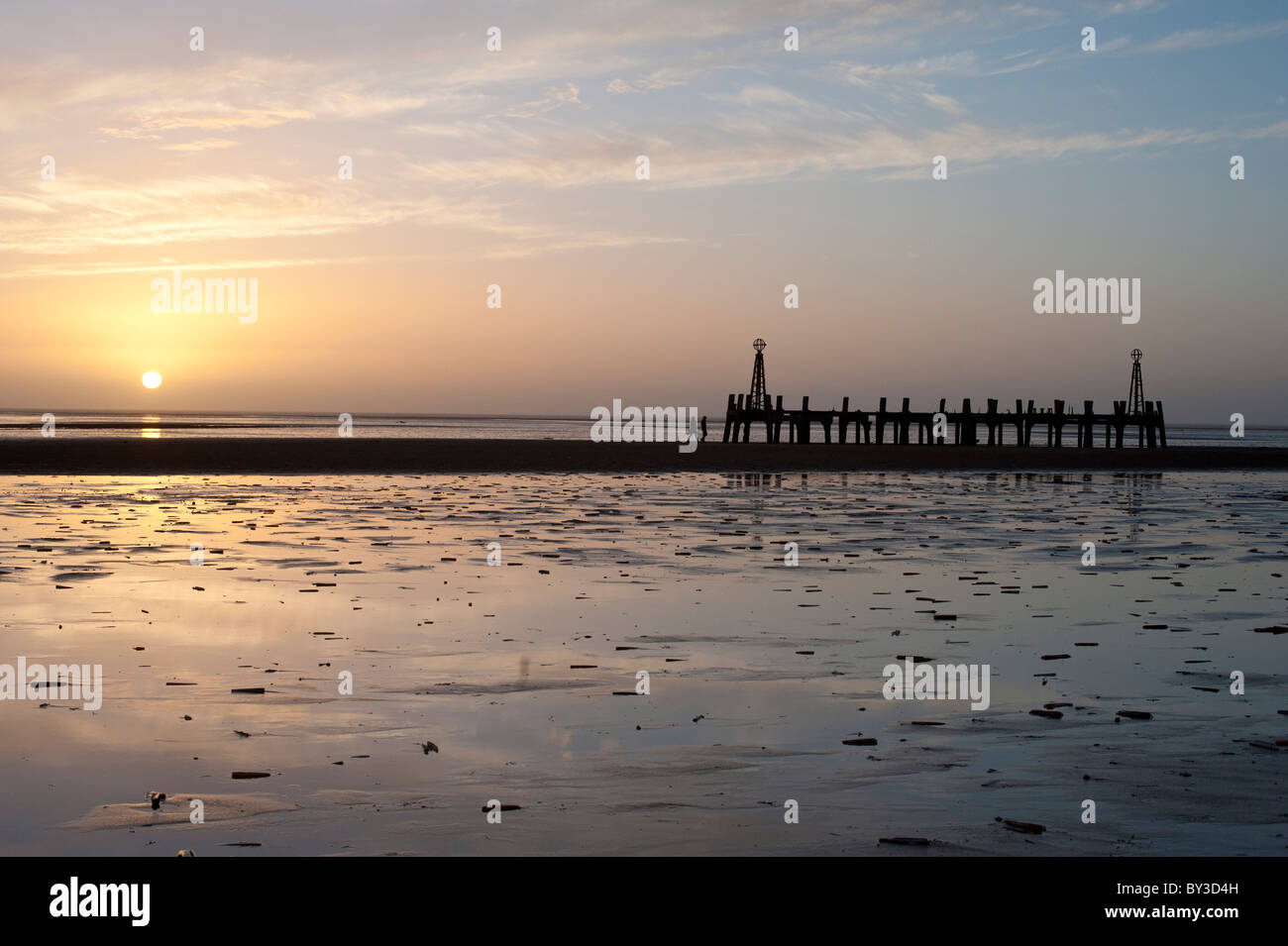The sun setting across the Ribble Estuary viewed from Lytham St Annes on the Fylde coast. Stock Photo
