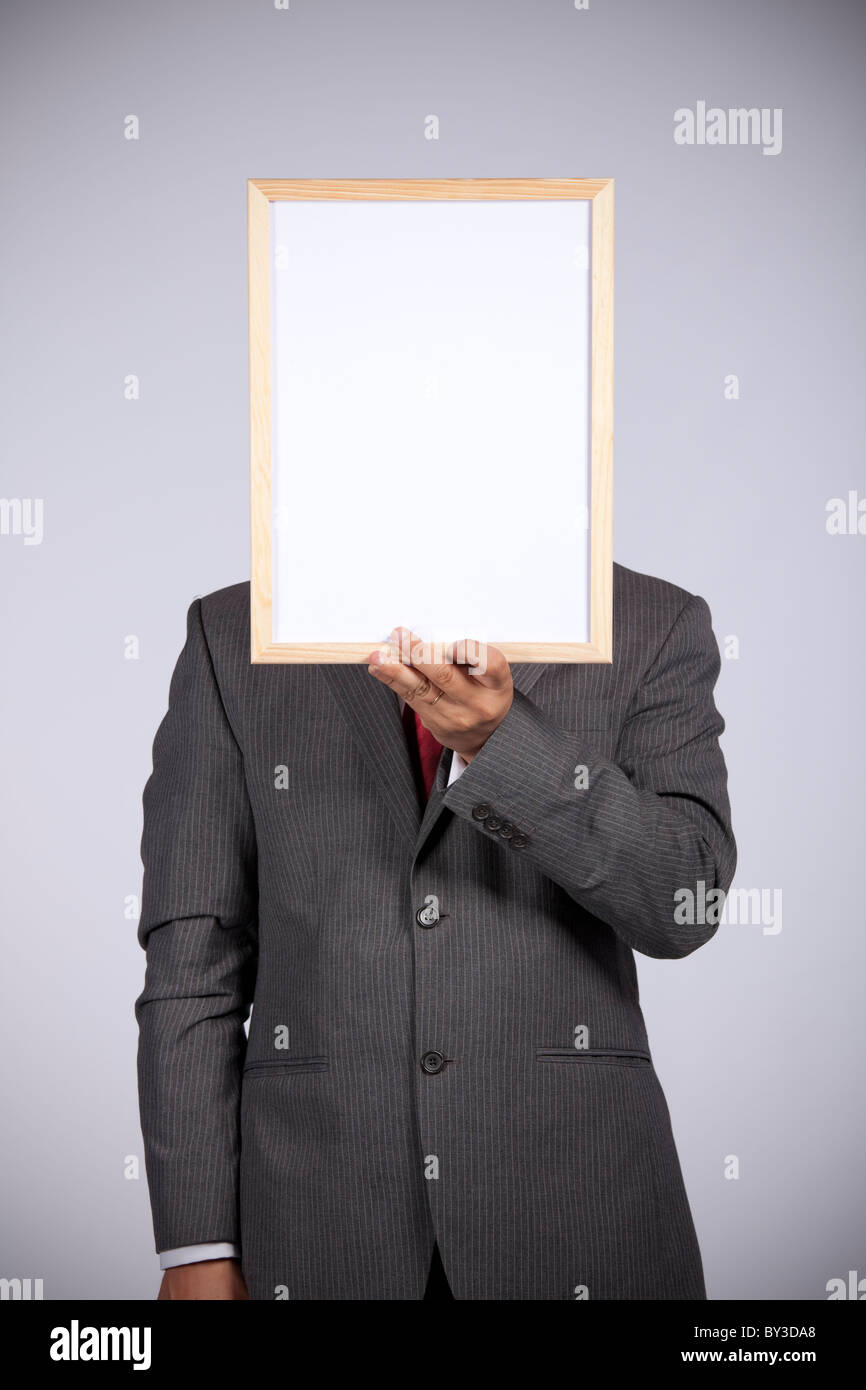 businessman holding a blank whiteboard Stock Photo
