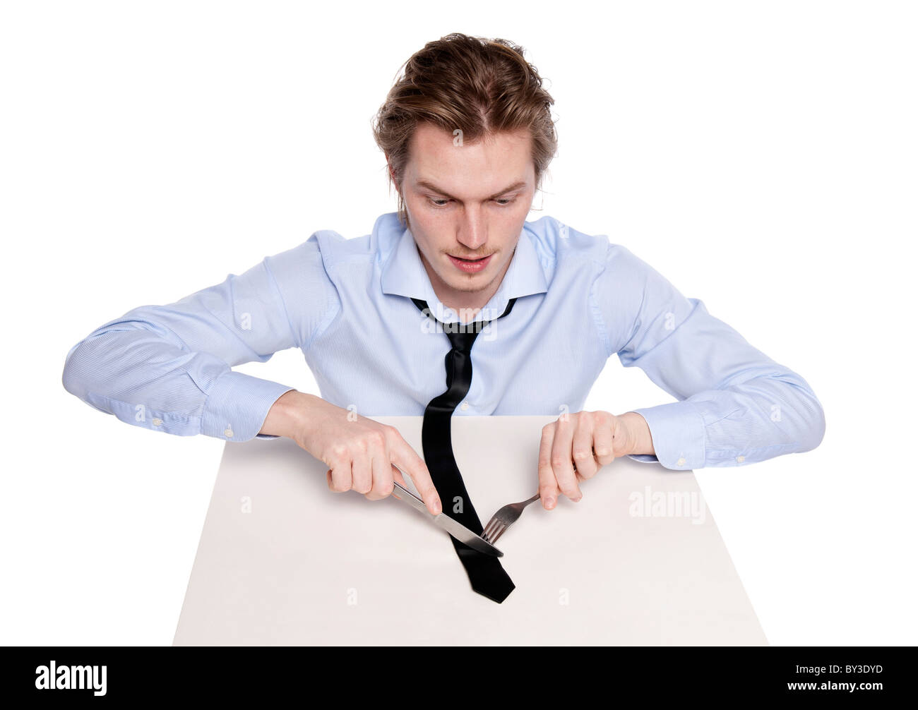 Young man eats his necktie. Studio photo of hungry man, isolated on white. Stock Photo