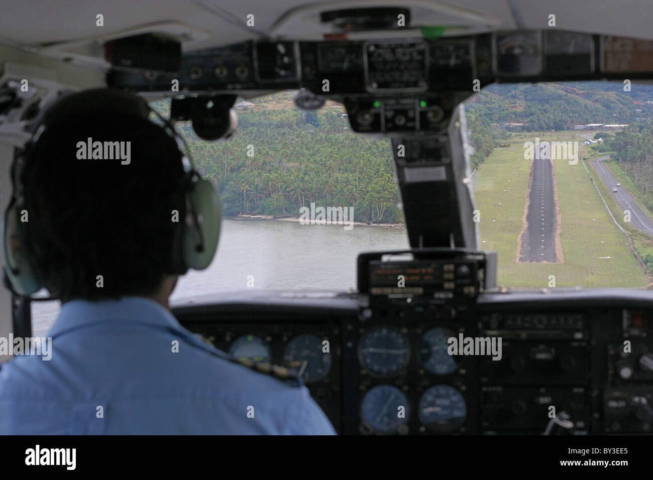 Aeroplane pilot as he is about to land a small plane on a runway in Fiji Stock Photo