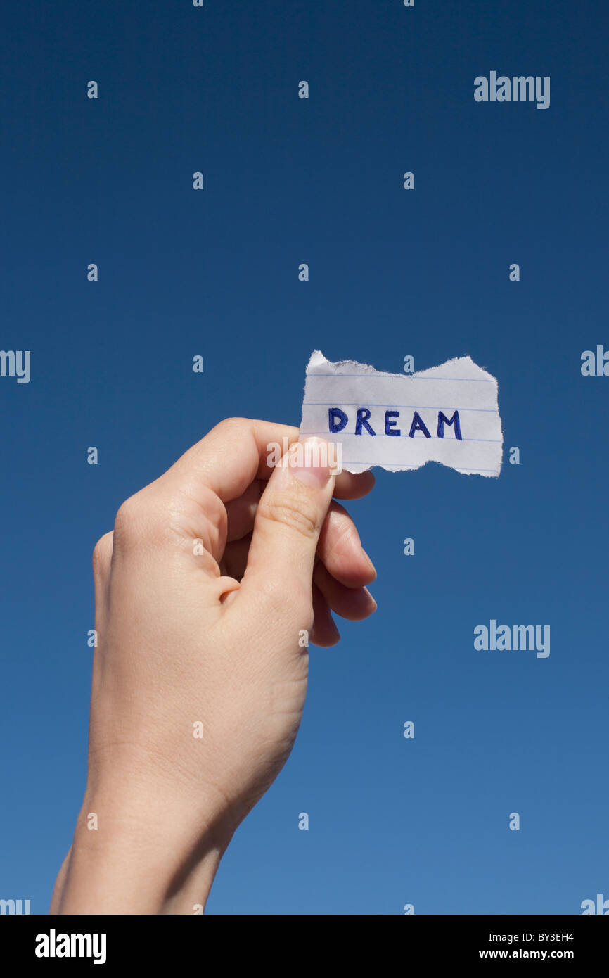 USA, Arizona, Winslow, Human hand holding paper with 'dream' text on it Stock Photo