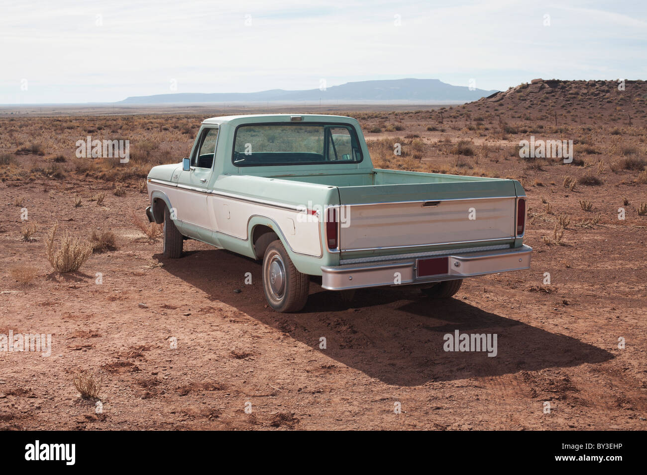 USA, Arizona, Winslow, Pick-up truck on desert Stock Photo