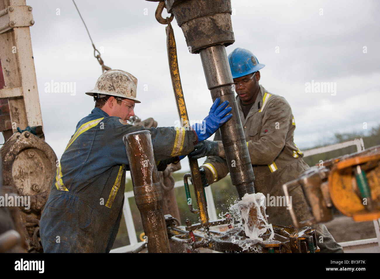 Oil workers drilling for oil on rig Stock Photo
