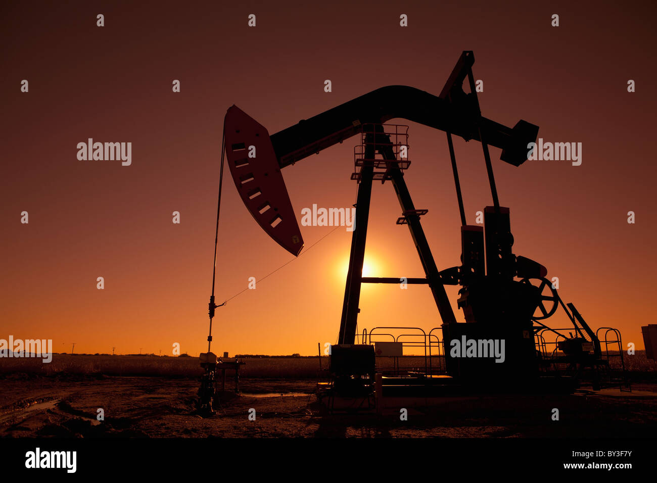 Silhouette of oil pump jack on rig Stock Photo