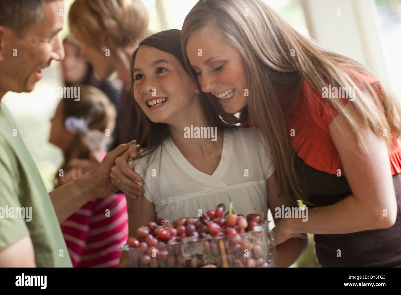 Girl (10 -11,) with family during celebration event Stock Photo