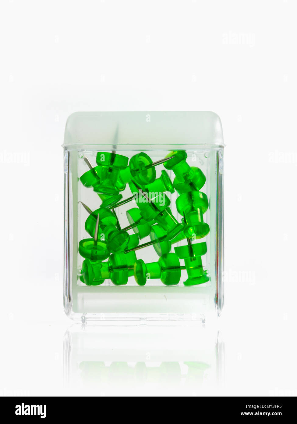 Studio shot of green thumbtacks in glass cube Stock Photo Alamy