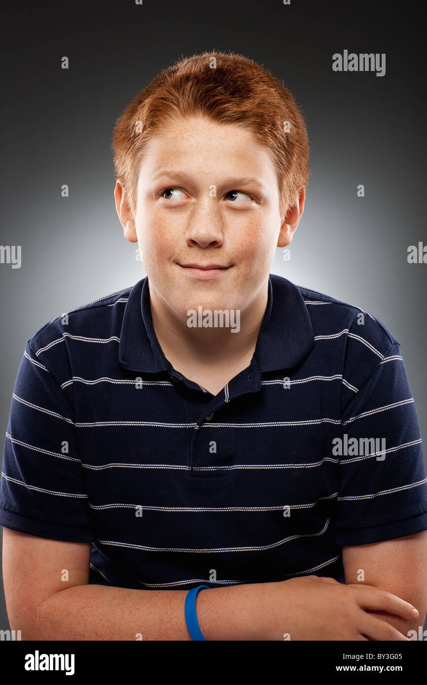 Portrait of redhead teenage boy (14-15) looking away, studio shot Stock ...