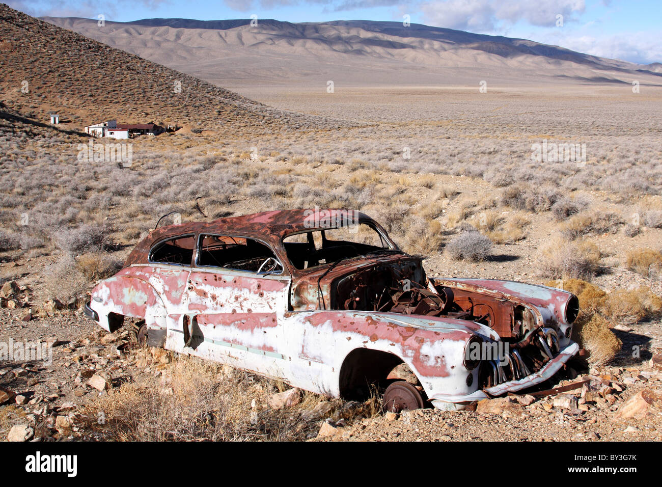 A 1947 Buick Roadmaster lies abandoned and rusting near Harrisburg and the Eureka Mine in Death Valley National Park. Stock Photo