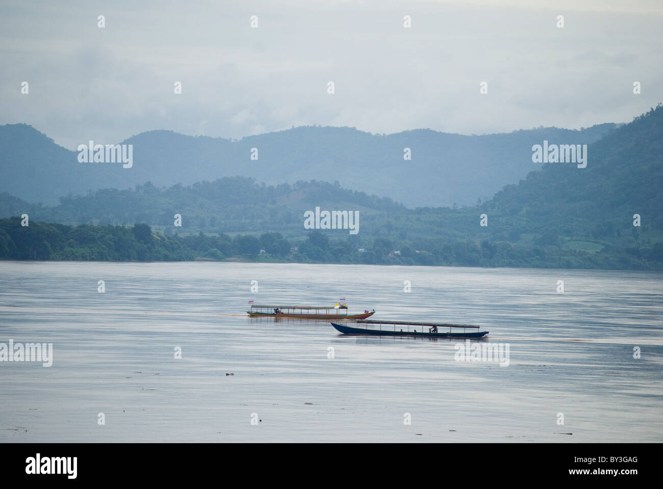 Boats running across the Mekong river border between Thailand and Laos at Chiang Khan, Loei. Stock Photo