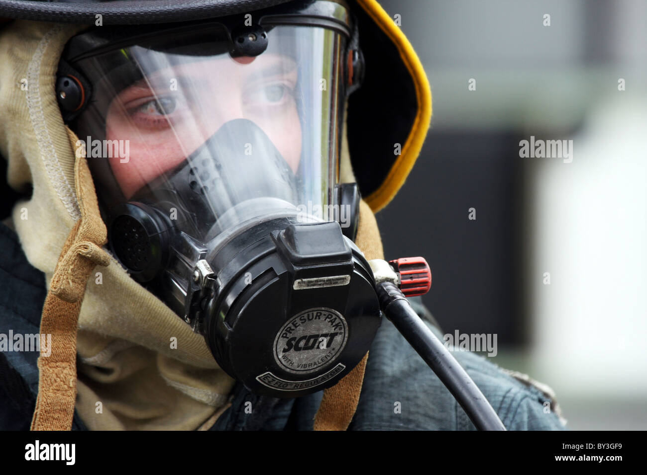 A firefighter in protective breathing gear and mask Stock Photo