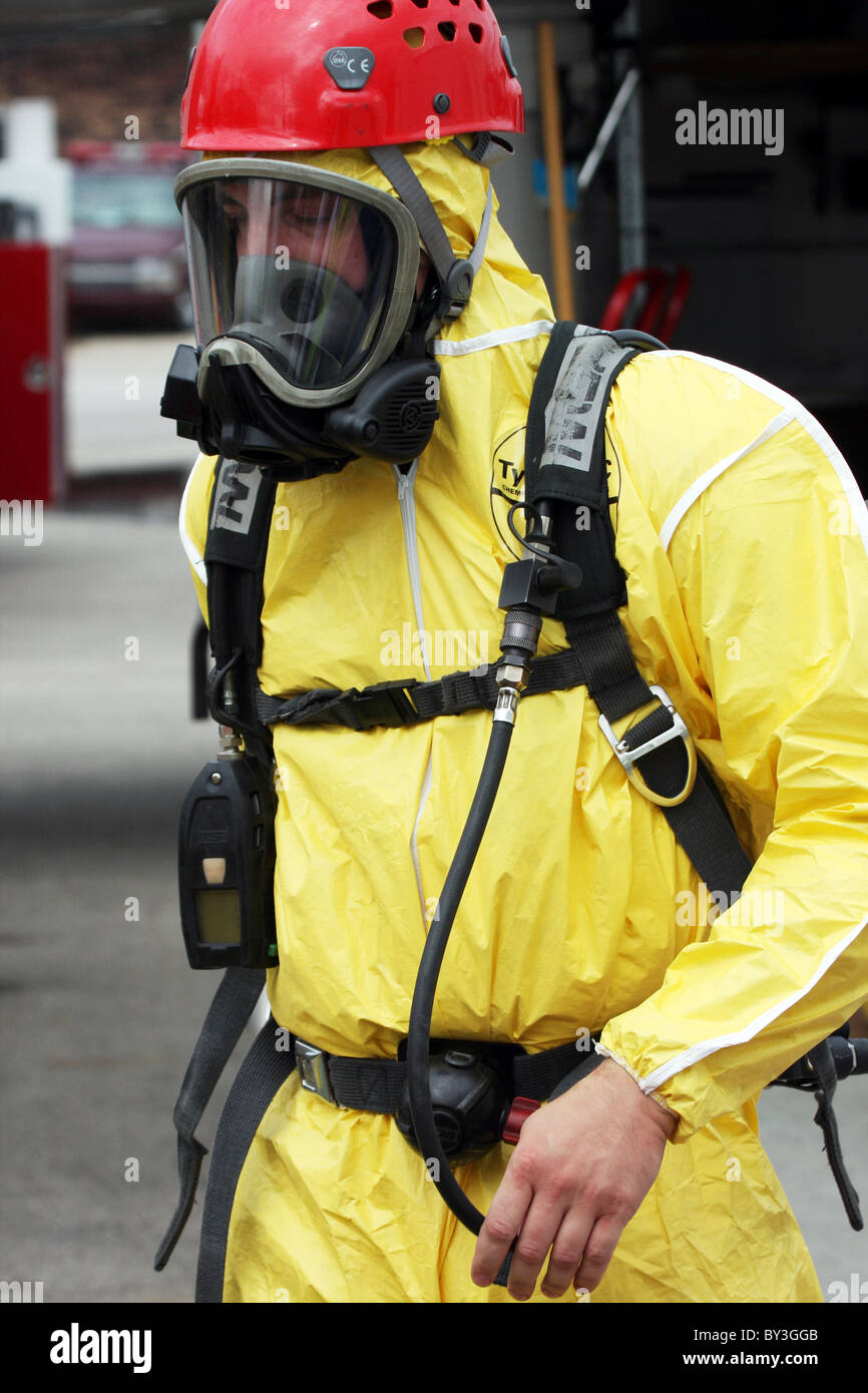 A firefighter in a secured the hazmat suit walking at a chemical haz mat spill incident Stock Photo