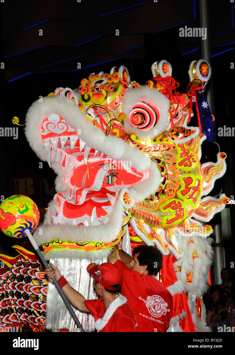A large dragon takes part in the Chinese New Year twilight parade in Sydney, Australia; dragon dance; Chinese dragon costume; multi-cultural festival Stock Photo