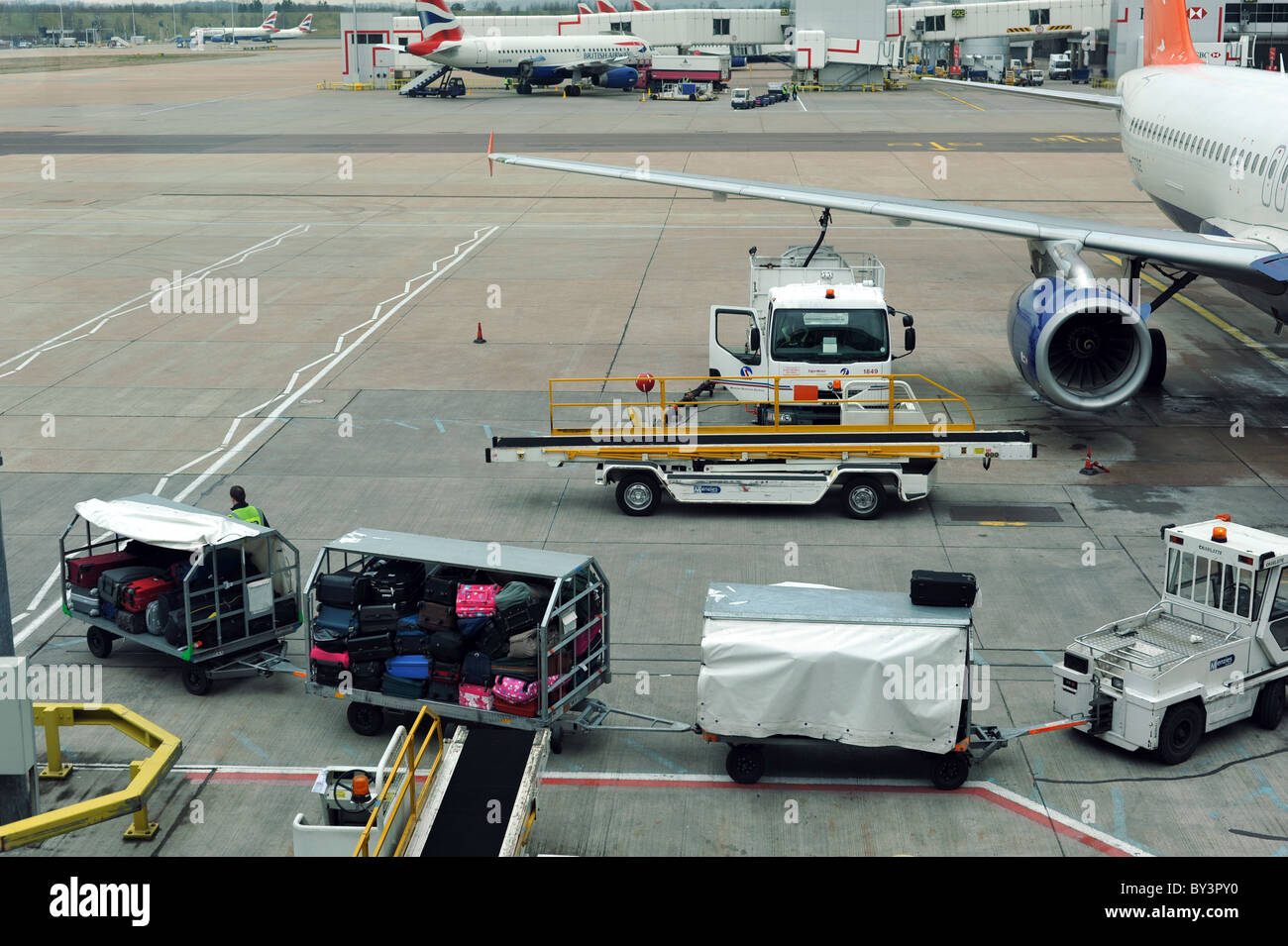 Baggage handlers loading hold luggage onto an aircraft Gatwick