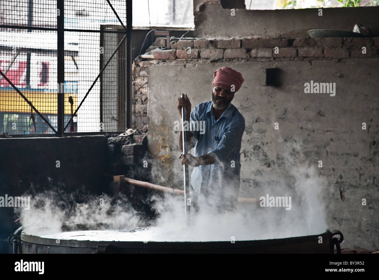 Stirring the dal Stock Photo