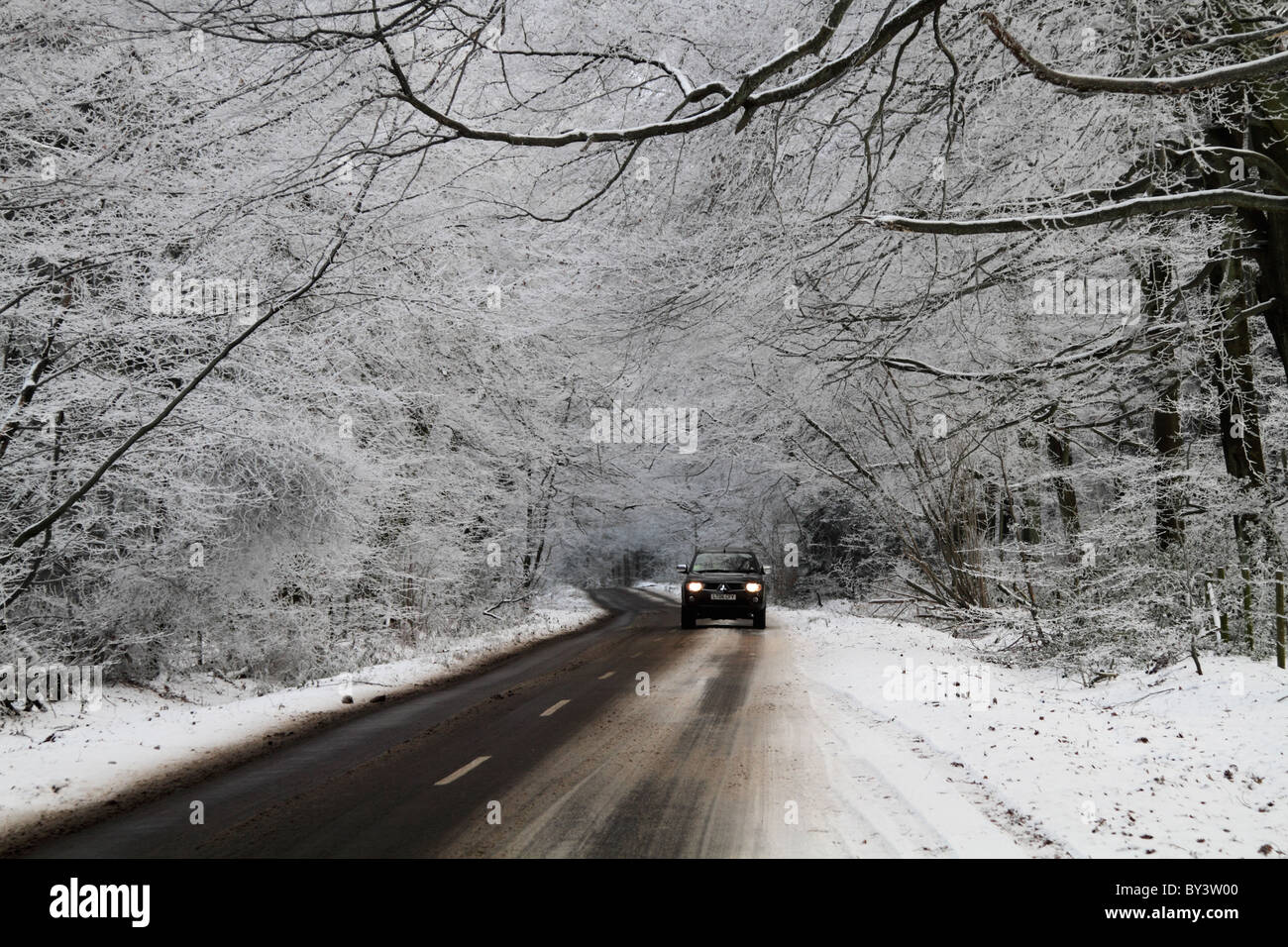 Winter driving country road hazardous conditions icy frosty Stock Photo