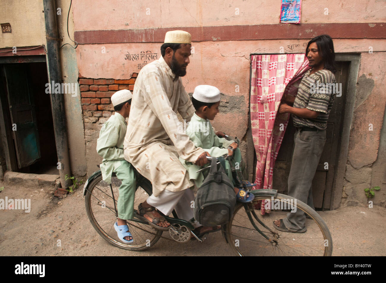 Muslim father and sons on a bicycle in Kathmandu, Nepal Stock Photo