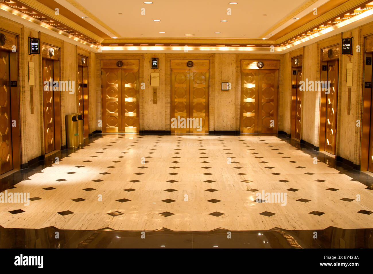 Building lobby with golden elevators Stock Photo