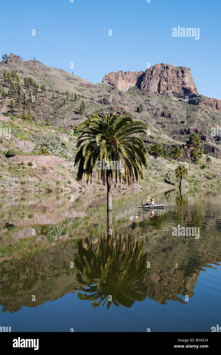 woman in small rowing boat on presa (reservoir) at Soria in the mountains of Gran Canaria. Canary Islands, Spain Stock Photo