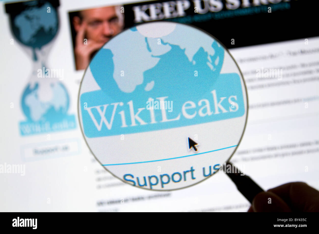 Wikileaks website page with Wikileaks logo, magnifying glass, and Julian Assange. Stock Photo