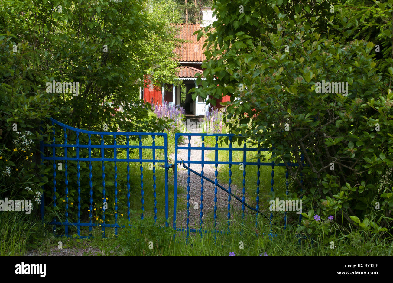 Small cottage with blue gate Stock Photo Alamy