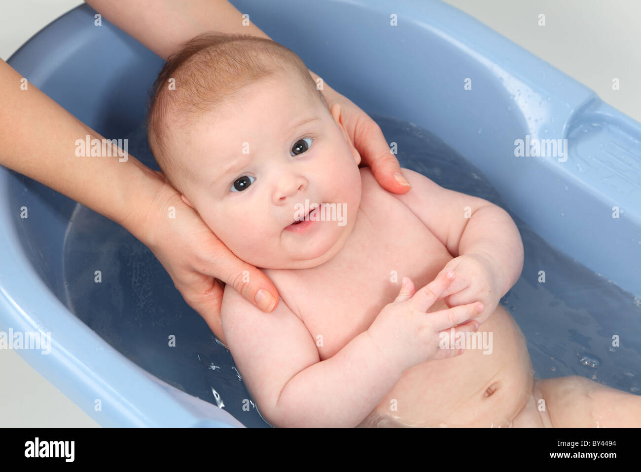 Three month old baby girl bathing Stock Photo Alamy